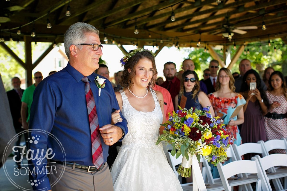 Bride and father walk down aisle